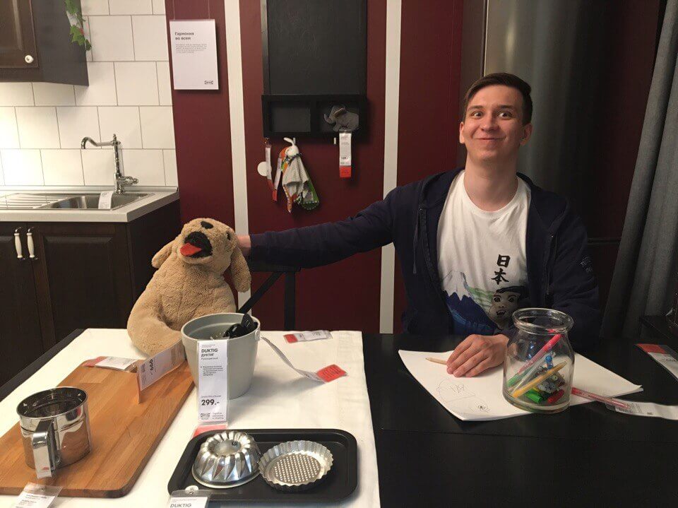 Smiling Georgy petting a plushy dog in IKEA